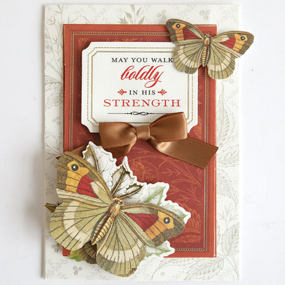 Send heartfelt support with the Prayer Sentiment Rub On Transfers, featuring layered butterflies, a brown ribbon bow, and the inspiring message "May you walk boldly in His strength" on a red and white background.