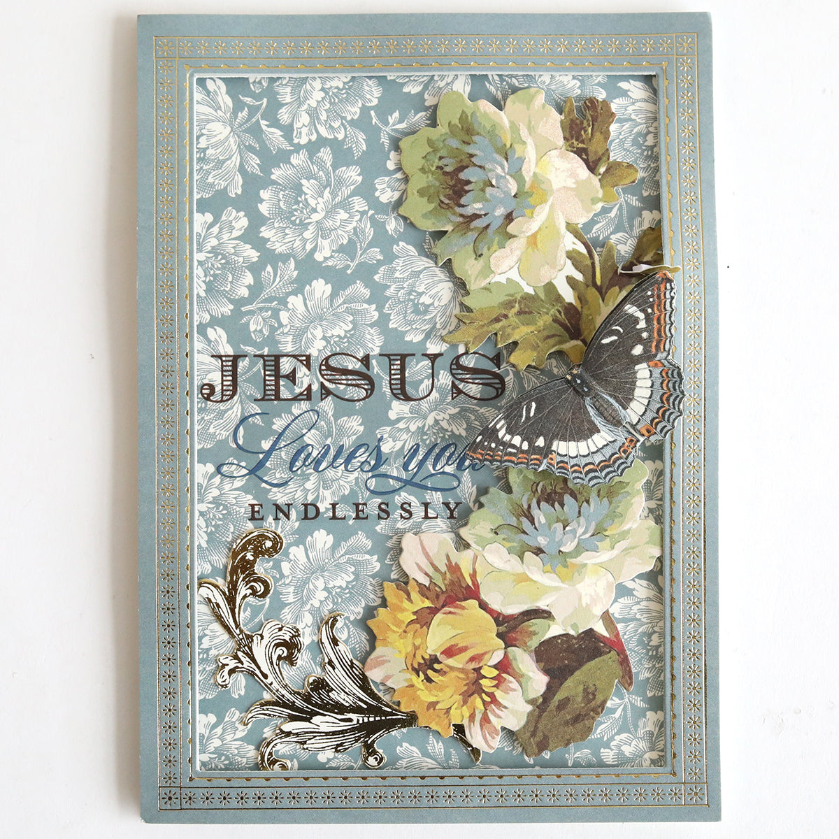 The Prayer Sentiment Rub On Transfers feature floral and butterfly designs on a blue background with "Jesus loves you endlessly" in decorative lettering—ideal for heartfelt encouragement and support.