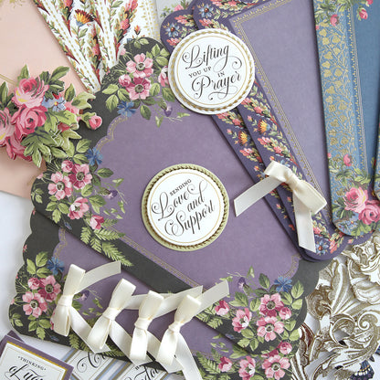 The Simply Sympathy Card Making Kit features floral-themed cards and bookmarks crafted from quality supplies, complete with supportive messages, ribbons, and decorative edges, all arranged neatly for an elegant display.
