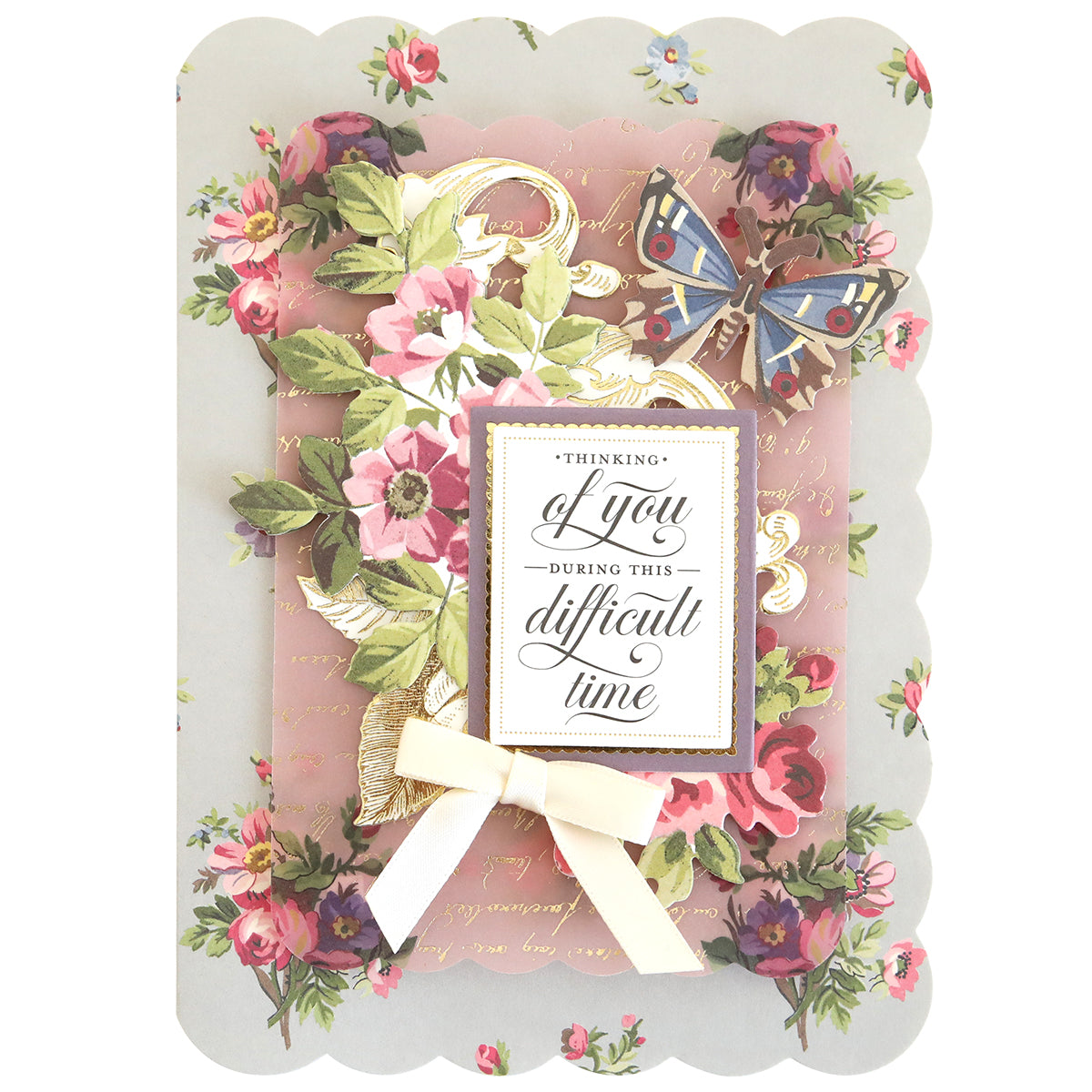 The Simply Sympathy Card Making Kit features floral and butterfly designs, a gold script background, and a white ribbon bow. Ideal for heartfelt handmade sympathy cards with the message: "Thinking of you during this difficult time.