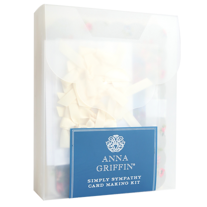 A transparent box labeled "Simply Sympathy Card Making Kit," containing cream-colored ribbons and card making supplies for creating elegant handmade sympathy cards.
