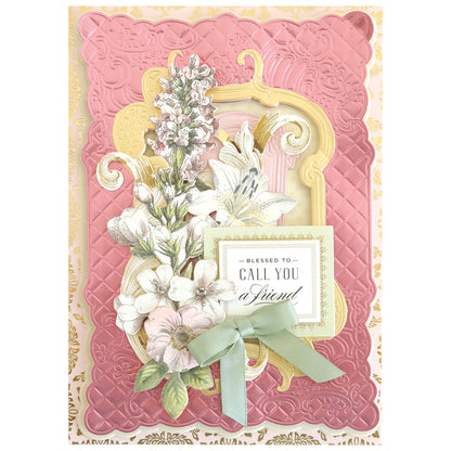 Greeting card with pink and gold embossed borders, dimensional frames made with the Floral Lattice Frame 3D Die Set, floral illustrations, a green ribbon, and the message “Blessed to call you a friend.”.