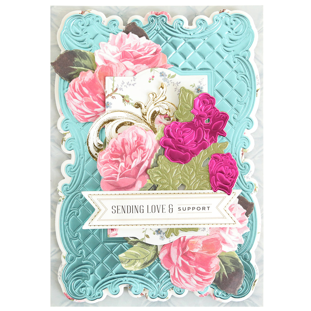 The Tufted Rose Concentric Frames 3D Die Set creates a decorative card with pink and purple flowers, green leaves, and a blue embossed background, featuring a "SENDING LOVE & SUPPORT" banner and elegant layered frame accents.
