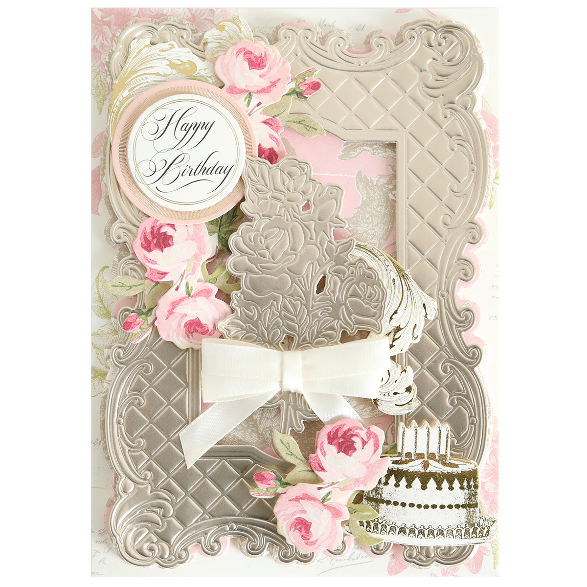 The Tufted Rose Concentric Frames 3D Die Set creates ornate birthday cards with embossed silver frames, pink roses, a white bow, layered “Happy Birthday” text, and a decorated cake illustration with candles.