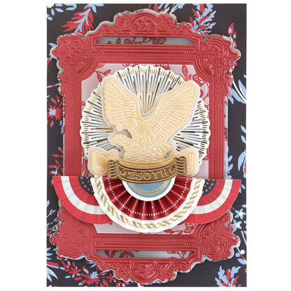 A decorative card showcases a gold eagle emblem labeled "250TH," red ornate frames made with the Pretty Patriotic 3D Frame Die Set, and red, white, and blue bunting on a floral background—ideal for unique paper crafts.
