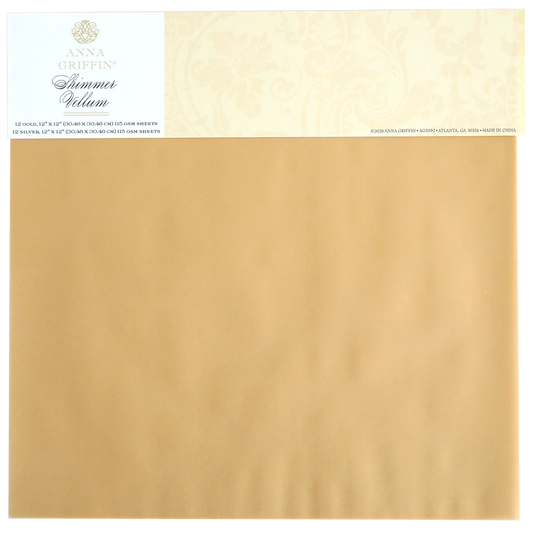 A package of Shimmer Vellum Papers in gold, featuring a 12" x 12" sheet with the product label on top—ideal for elegant paper crafting projects.