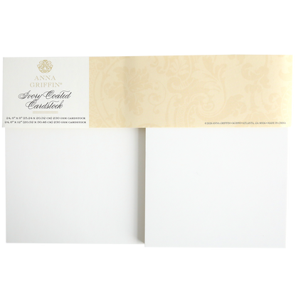 A photo of Ivory Coated Cardstock, showing a pack with two blank 260 gsm sheets and a beige decorative label with gold text at the top.