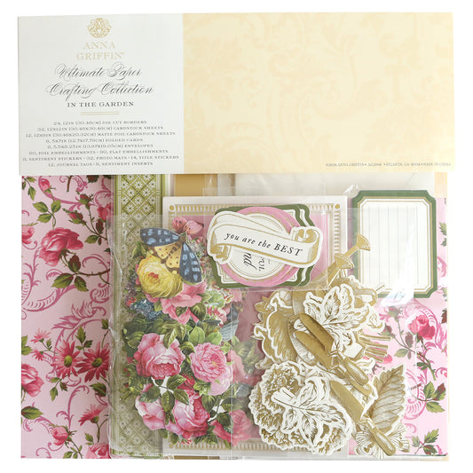 The In The Garden Ultimate Paper Crafting Kit is ideal for scrapbooking and cardmaking, offering floral, butterfly, and gold foil embellishments, tags, and decor in a clear package with a pink floral background.