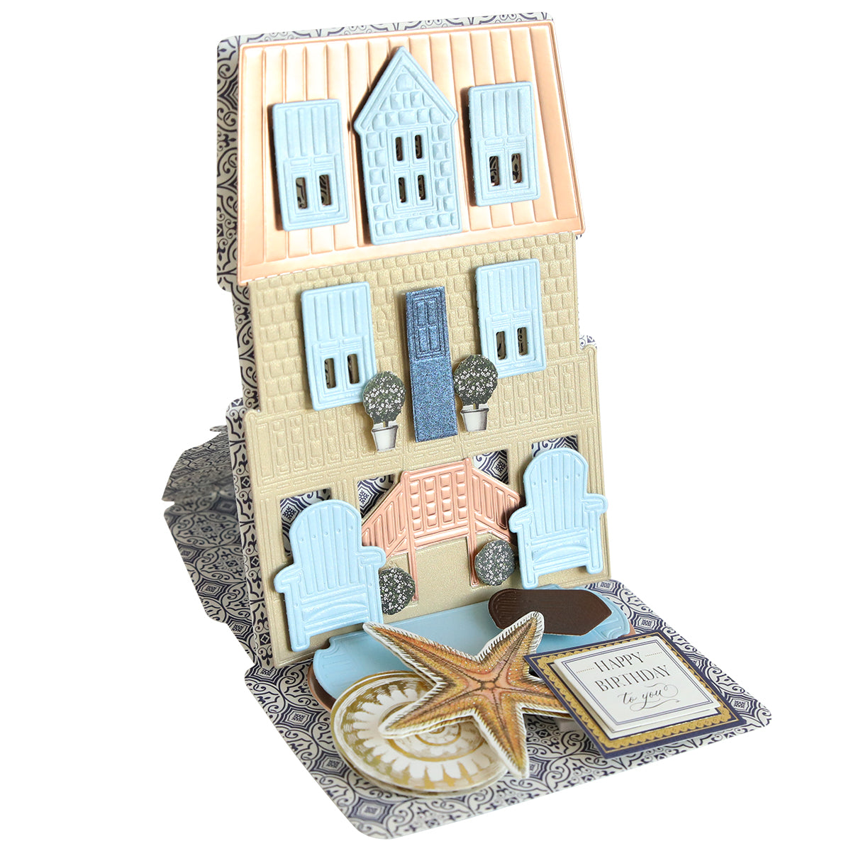 The Summer House 3D Easel Dies create a pop-up beach cottage card with a pastel house, blue shutters, patio chairs, trees, starfish, and a “Happy Birthday to you!” sentiment—perfect for summer house crafting fans.