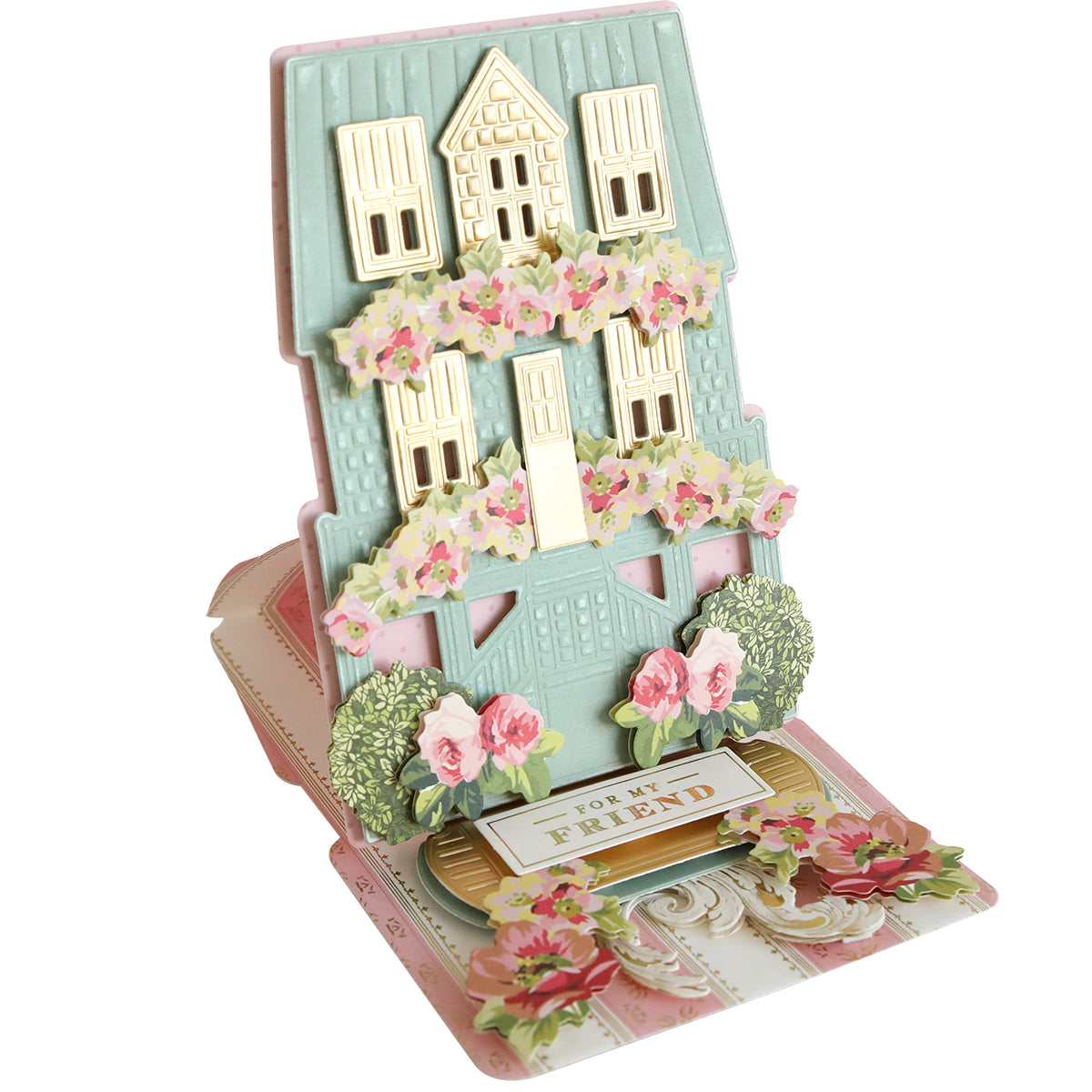 Pop-up greeting card made with Summer House 3D Easel Dies, featuring a pastel house adorned with gold accents and pink flowers, inspired by a beach cottage, and finished with a "For My Friend" message at the base.
