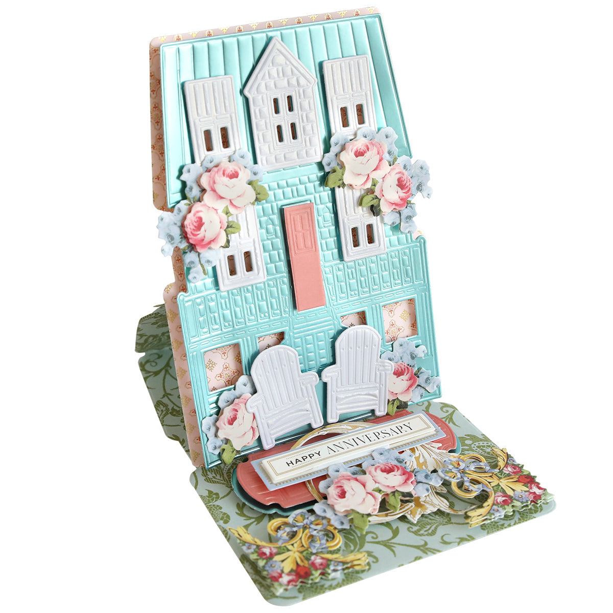 The Summer House 3D Easel Dies create a decorative card featuring a pastel house with windows, floral accents, two white chairs, and a "Happy Anniversary" message—ideal for summer crafting or as a charming beach cottage card.