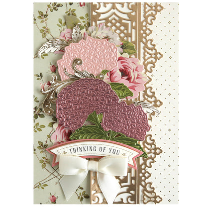 The Hydrangea 3D Dies let you create layered pink and purple embossed hydrangea blooms with gold trim, a white bow, and a “Thinking of You” banner—ideal for handmade cards and inspiring your creative projects.