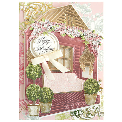 The Front Porch Scene Dies are perfect for creating handmade birthday cards with a pink house, white sofa, potted plants, hanging basket, and floral decorations. Add dimensional "Happy Birthday" designs with this versatile die set.