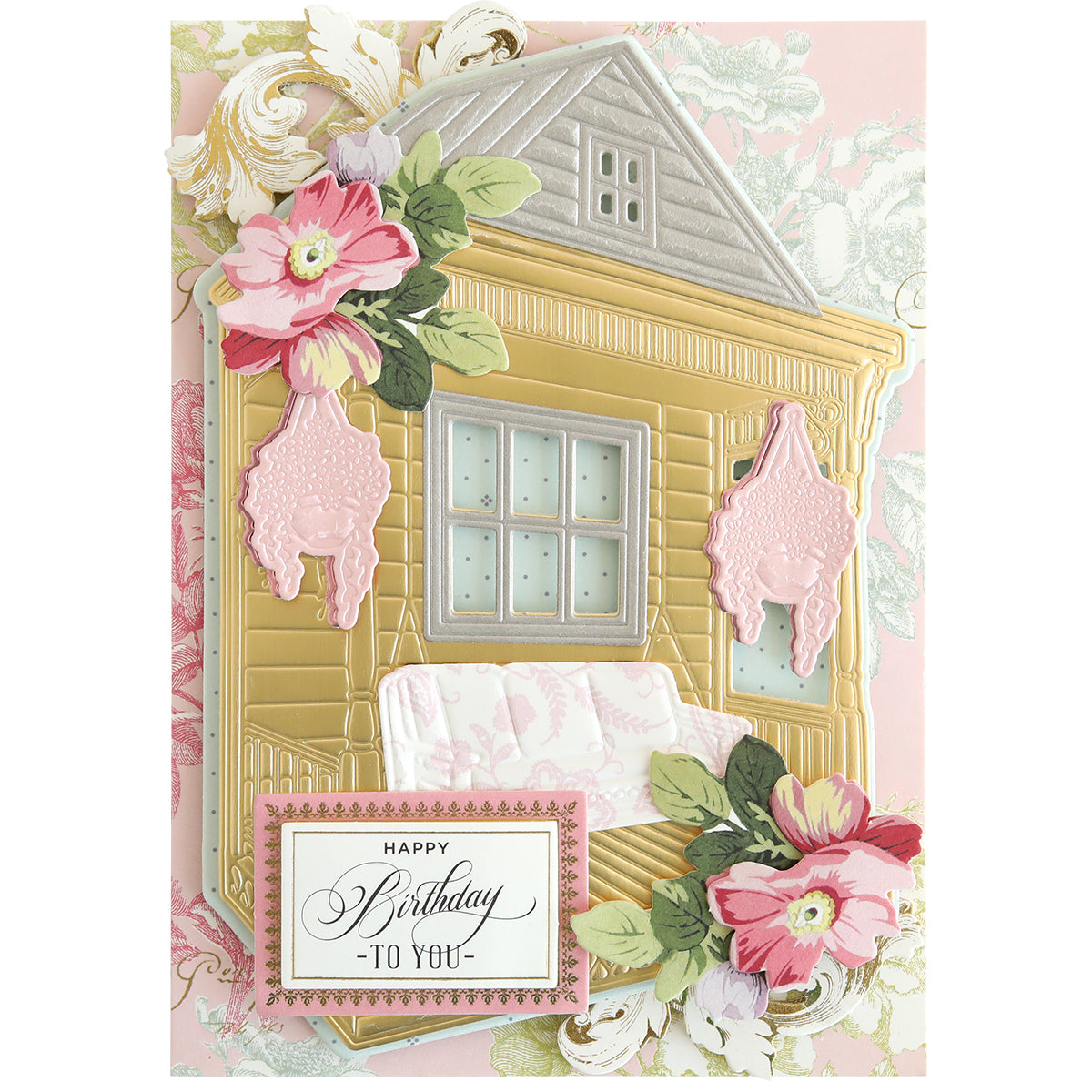A handmade card made with Front Porch Scene Dies features a gold and gray house, white porch swing, pink florals, and "Happy Birthday to You" on a white panel for added dimension.