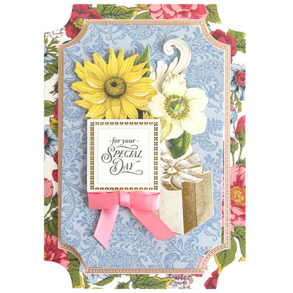 Create beautiful handmade cards with the Simply Summer Card Making Kit featuring a floral greeting card design—a yellow sunflower, white flower, gold-trimmed gift, pink ribbon, and "for your SPECIAL DAY" text on a blue patterned background.