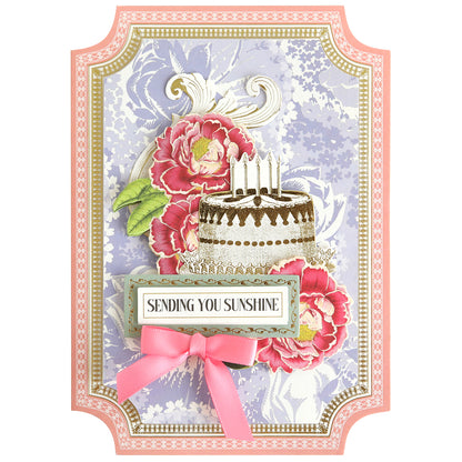 Create beautiful handmade cards with the Simply Summer Card Making Kit, featuring a decorative card with a floral background, cake with candles, pink flowers and bow, and a "Sending You Sunshine" label.