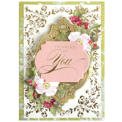 The Rose Garden Frame and Sentiment Gilded Foil Frame Plates create a decorative card with floral designs, a rose frame, gold accents, and "Thinking of You" in elegant script on a pink label.
