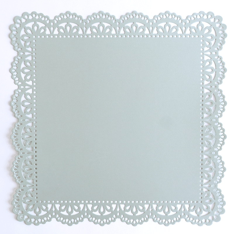 An image of a paper doily on a white surface.