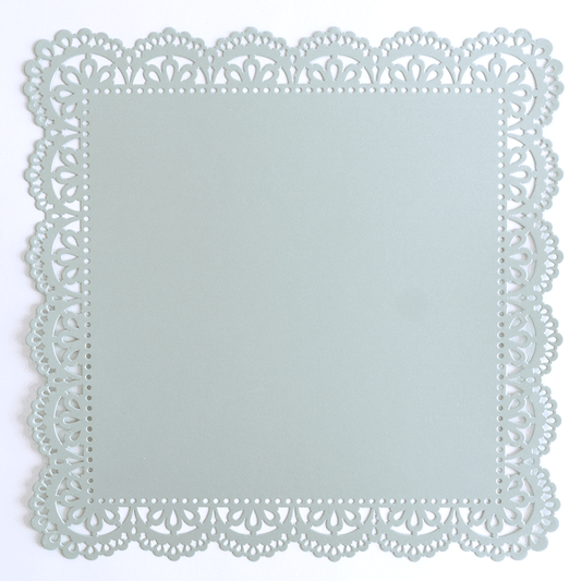 An image of a paper doily on a white surface.