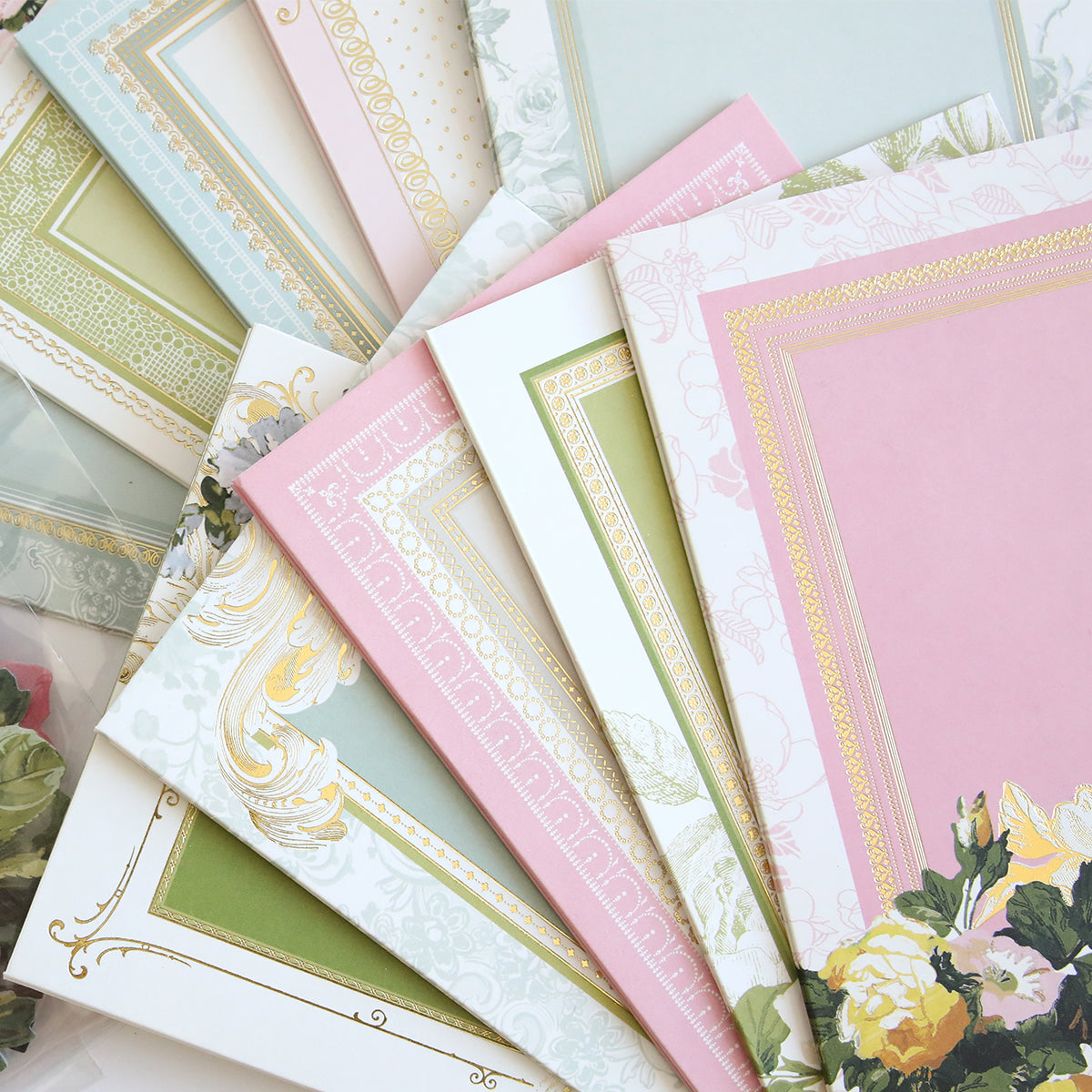 A pastel fan-shaped set of decorative papers with gold borders and floral designs, ideal for use with the Folded Rose Card Making Kit or for adding 3D embellishments to your cards.