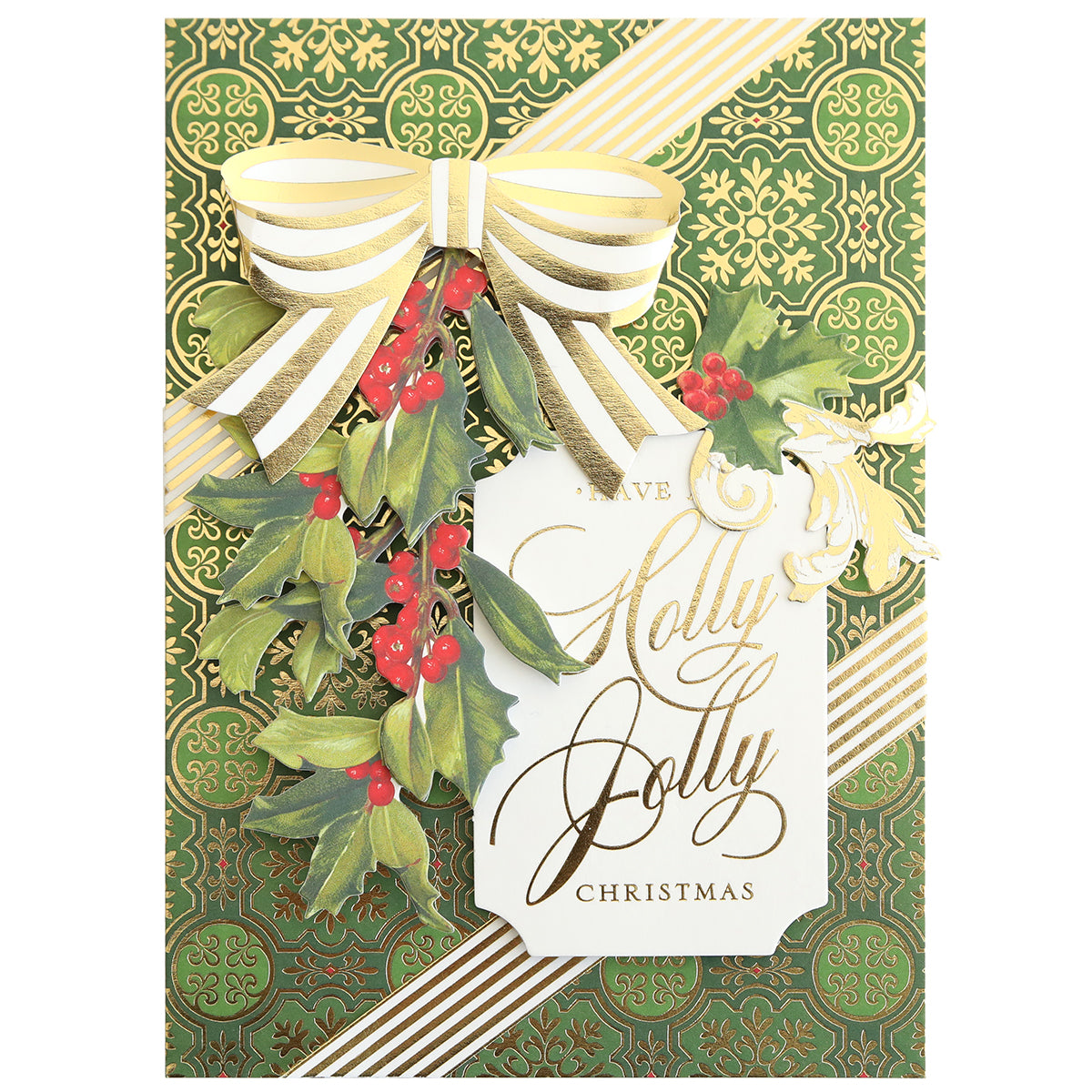 Craft a festive card with the Christmas Grace Card Making Kit, showcasing gold and green designs, a gold striped ribbon bow, holly leaves and red berries, plus a “Have a Jolly Jolly Christmas” tag.