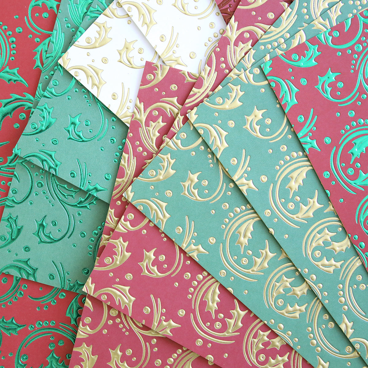 Christmas Grace Tonal Foil Card Stock features embossed red, green, and white sheets with metallic holly and swirl patterns—ideal for holiday card making or adding festive flair to your Christmas projects.