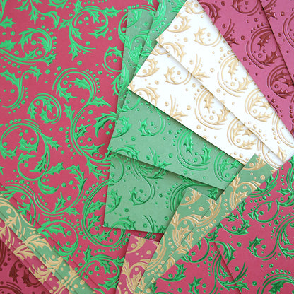 Christmas Grace Tonal Foil Card Stock features embossed sheets in green, red, and white with gold and green holly designs—ideal for holiday card making.