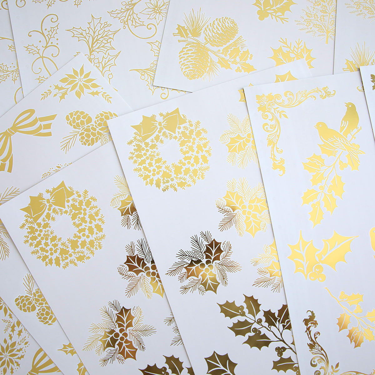 Holiday Nostalgia Foil Rub Ons feature metallic gold holiday designs—wreaths, holly, pinecones, poinsettias, ribbons, and birds—ideal for adding vintage shimmer to your Christmas papercrafting projects.