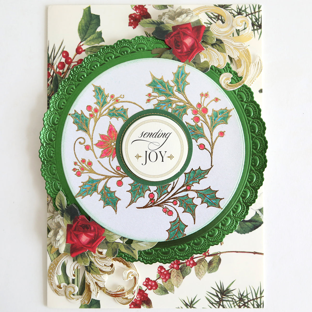 Holiday Nostalgia Foil Rub Ons feature a green embossed circle, holly and floral designs, red roses, vintage shimmer accents, and the message “sending JOY”—perfect for Christmas papercrafting projects.