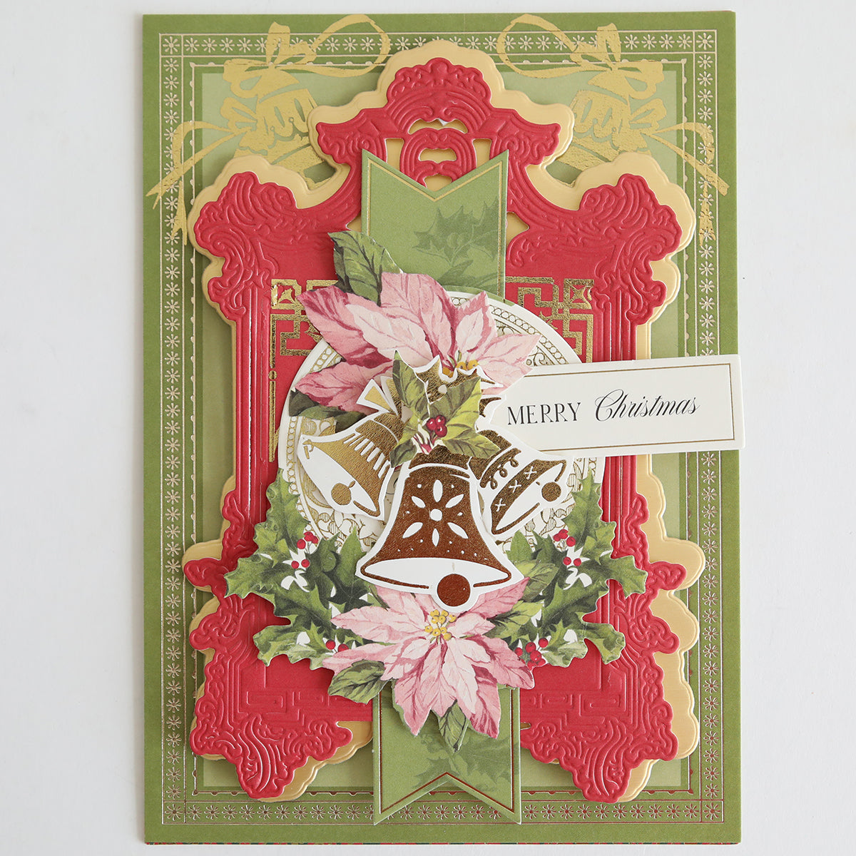 The Holiday Nostalgia Foil Rub Ons add vintage shimmer to ornate Christmas cards with layered red, gold, and green designs featuring poinsettias, holly, golden bells, and a “Merry Christmas” message—perfect for papercrafting.
