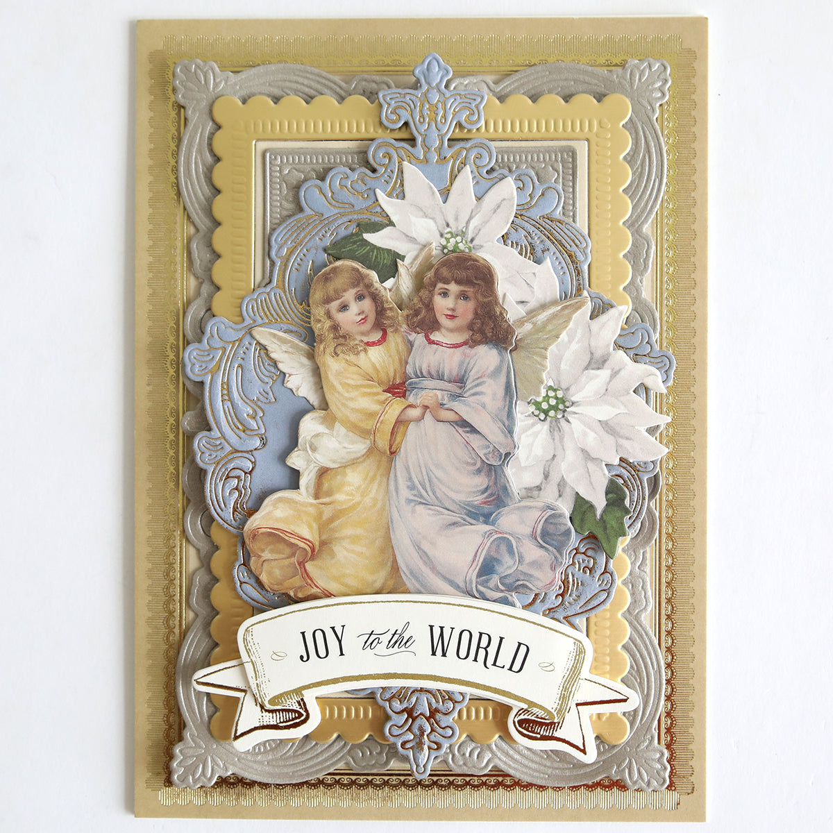 Holiday Nostalgia Embellishments feature vintage-style angels in yellow and blue robes, embossed gold and silver borders, white poinsettias, and a "JOY to the WORLD" banner—ideal for holiday crafts or as Christmas card decorations.