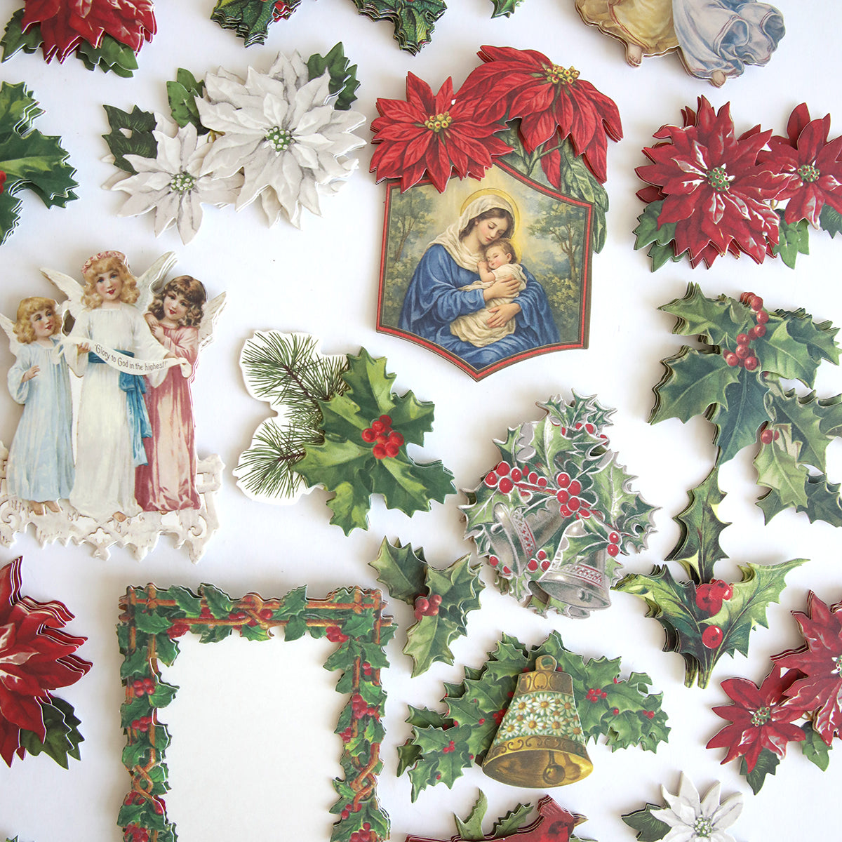 Holiday Nostalgia Embellishments features vintage-inspired Christmas cutouts—poinsettias, holly, bells, angels, a nativity scene, and a decorative frame—beautifully arranged on a white background.