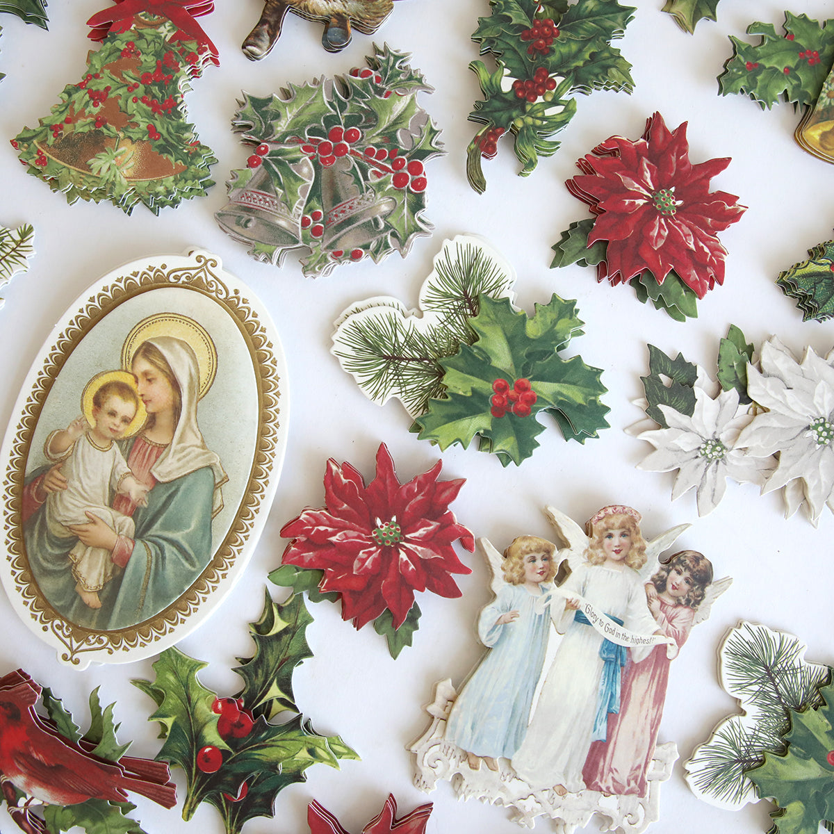 Holiday Nostalgia Embellishments: vintage-inspired Christmas cutouts with poinsettias, holly, pine branches, Madonna and Child, and three angels—ideal for holiday paper crafts or as festive accents.