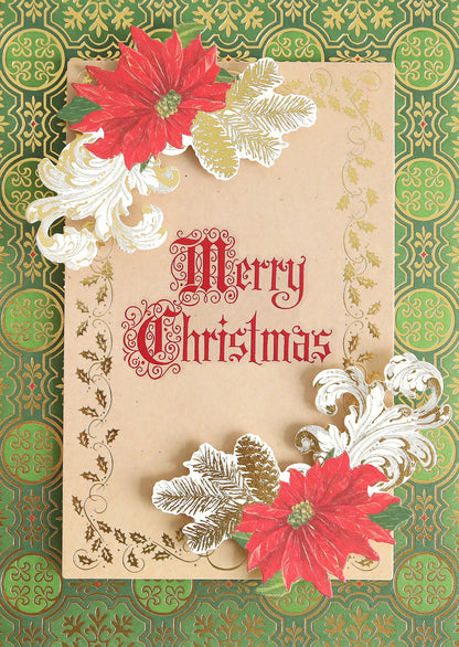 A Christmas card adorned with red poinsettias, gold leaves, and "Merry Christmas" in red on a brown background sits on a green patterned surface—a wonderful handmade creation to elevate your holiday crafts. Complete your design with Christmas Card Sentiment Rub Ons for an extra festive touch.