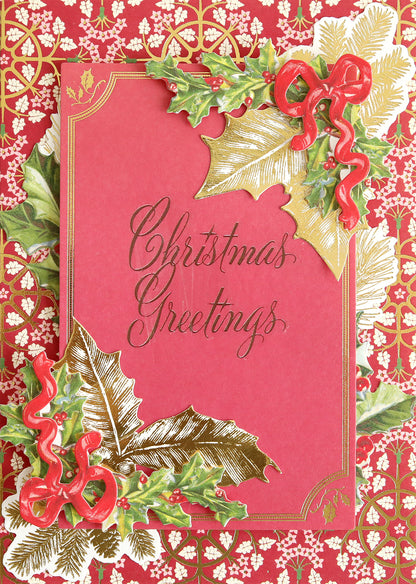 A beautiful handmade card for holiday paper crafts enthusiasts showcases the Christmas Card Sentiment Rub Ons featuring "Christmas Greetings" in elegant script, accented with gold borders, holly leaves, and red ribbon decorations against a red and gold patterned background.