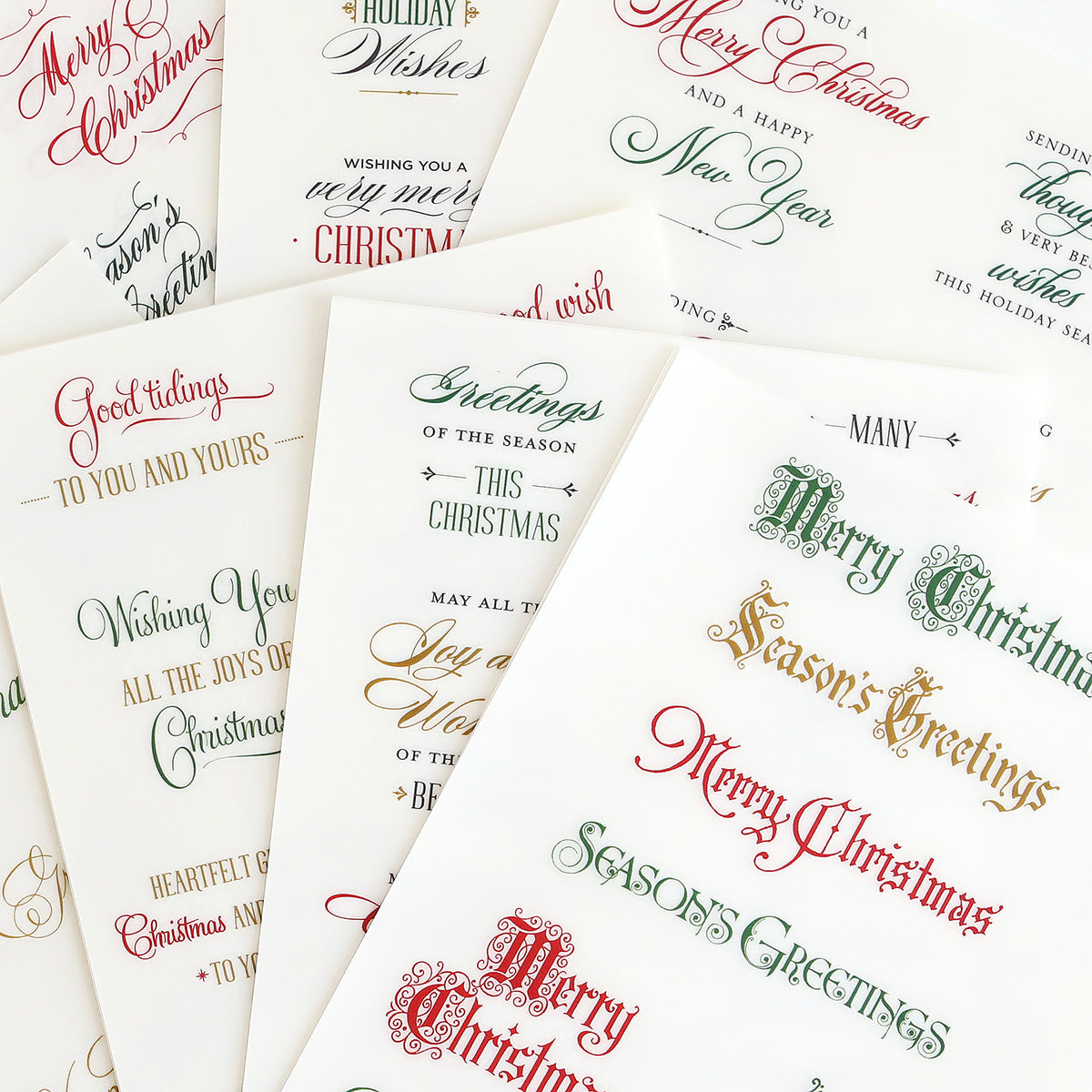 Add festive cheer to your holiday projects with Christmas Card Sentiment Rub Ons, featuring elegant red and green calligraphy greetings like "Merry Christmas" and "Season’s Greetings"—ideal for handmade cards or bringing a special touch to any holiday paper craft.