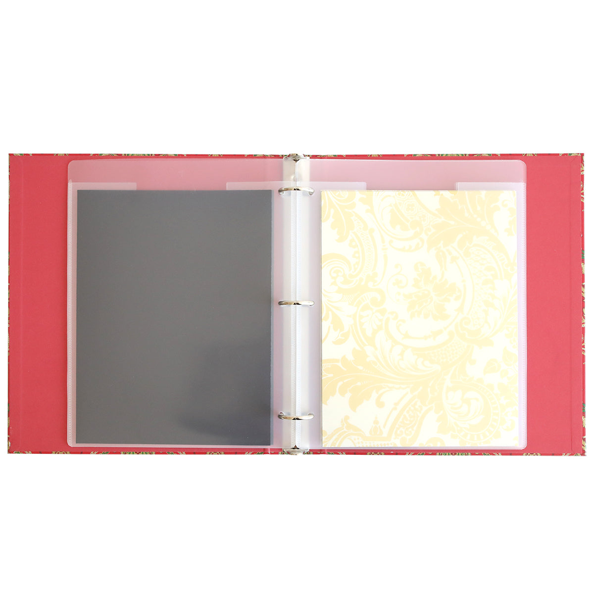 An open Christmas Jasmine Die Storage Binder with a pink interior, holding two plastic sheet protectors—one containing a gray sheet and the other a cream floral-patterned sheet—perfect for organizing your metal cutting dies or using as a festive holiday storage solution.