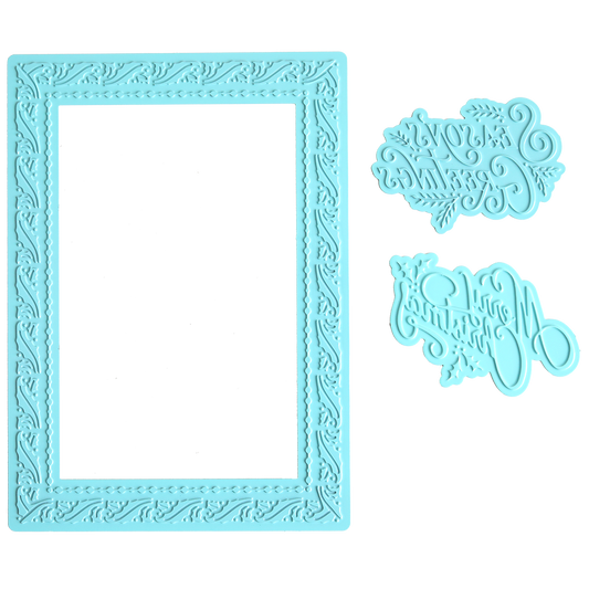 The Gilded Christmas Frame and Sentiments Hot Foil Plate features a blue rectangular decorative frame with intricate patterns, ideal for handmade holiday cards, plus two script-style decorative elements on the right.