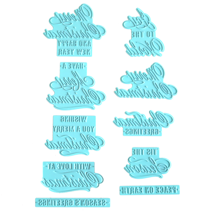 Eight blue plastic hot foil plates, styled after the "Gilded Small Christmas Sentiments Hot Foil Plates," are arranged on a white background. Featuring mirrored holiday greeting phrases reminiscent of classic Christmas designs, these plates may be tricky to read at first glance but are ideal for adding festive sentiment to your cards or baked goods.