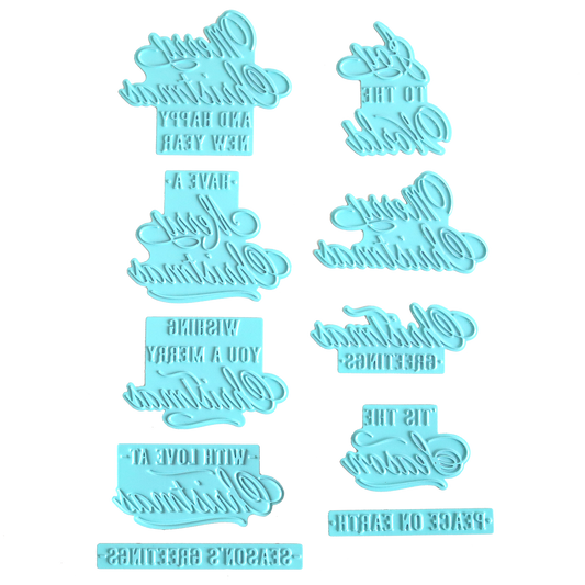 Eight blue plastic hot foil plates, styled after the "Gilded Small Christmas Sentiments Hot Foil Plates," are arranged on a white background. Featuring mirrored holiday greeting phrases reminiscent of classic Christmas designs, these plates may be tricky to read at first glance but are ideal for adding festive sentiment to your cards or baked goods.
