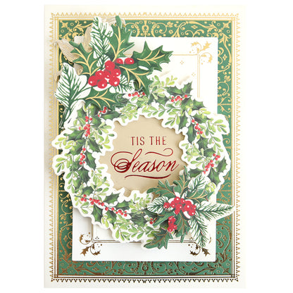 Share the spirit of the season with a decorative holiday card that showcases a beautiful green wreath adorned with red berries and elegantly framed by ornate gold and green borders. Featuring the sentiment "'Tis the Season" at its center, this design captures the refined look of foiled Christmas cards using the Gilded Small Christmas Sentiments Hot Foil Plates—perfect for adding a festive, heartfelt touch to your holiday correspondence.
