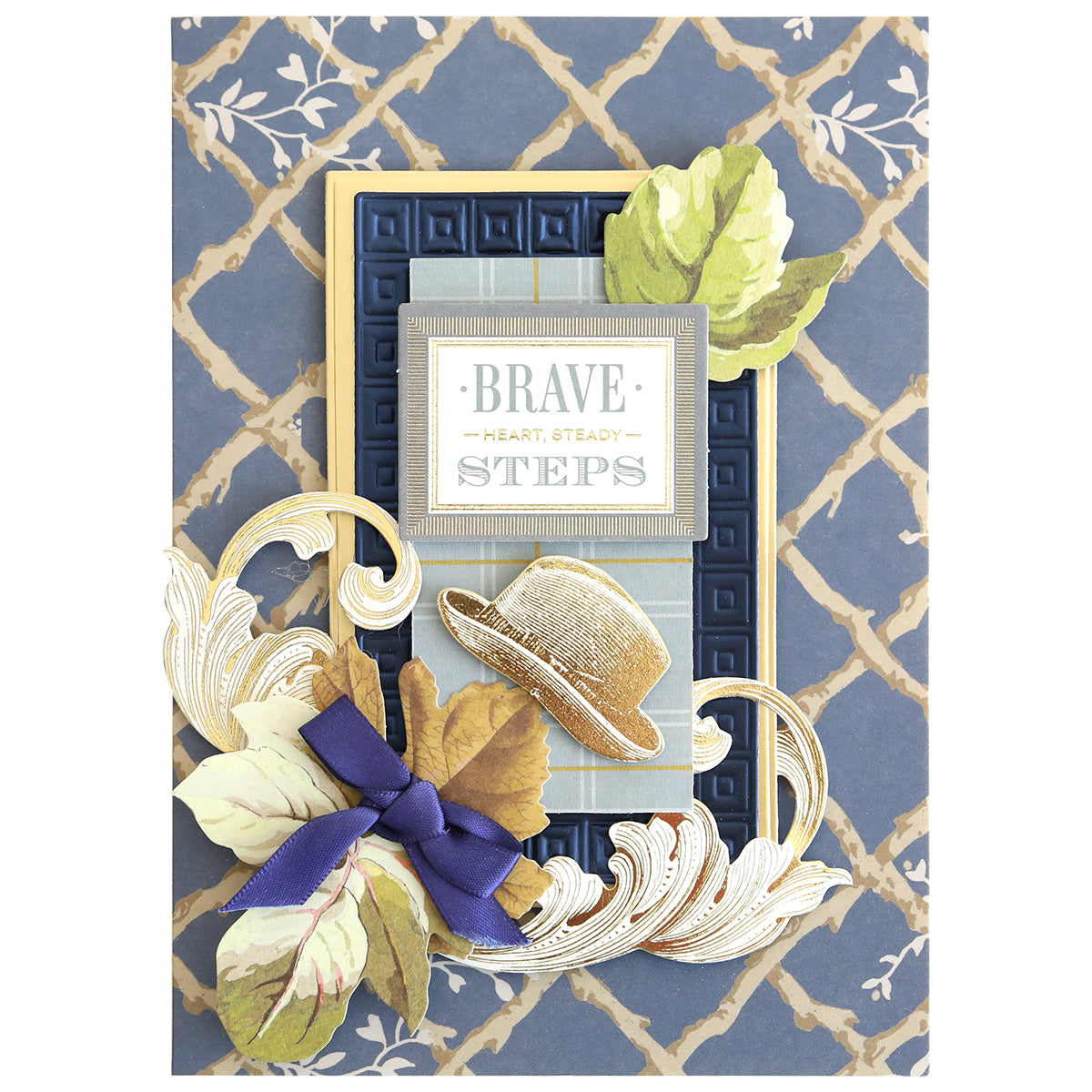 Crafted with Jack Double Sided Cardstock and Embellishments, this beautifully decorated card captures the charm of scrapbook designs, showcasing a hat, leaves, and ribbon accents alongside the phrase “BRAVE HEART, STEADY STEPS” set against a patterned blue and gold background.