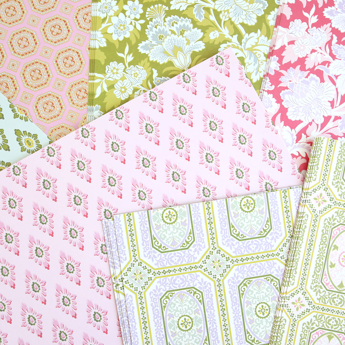 The Charlie Double Sided 12x12 Cardstock Collection offers beautifully layered sheets in pink, green, and white, featuring floral and geometric designs—perfect for your next paper crafts project.