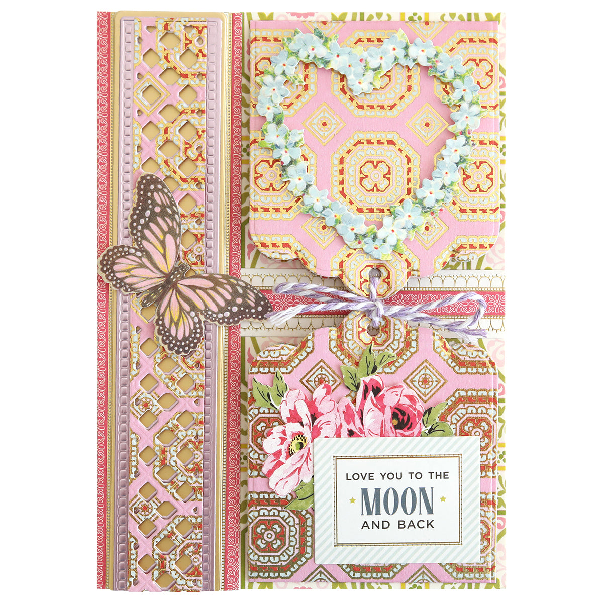 Greeting card featuring ornate patterns, a floral heart, butterfly, and flowers, tied with a ribbon. Expertly crafted using layered paper techniques and the Charlie Double Sided 12x12 Cardstock Collection for added dimension. A label displays “LOVE YOU TO THE MOON AND BACK” in striking black and gold text.