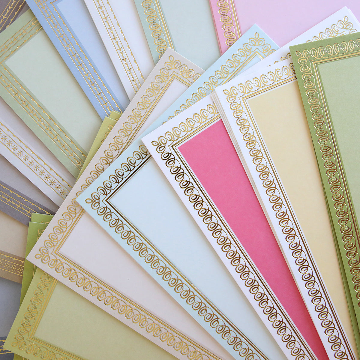 Timeless Photo Mats and Card Layers feature ornate, pastel-colored papers with gold borders, displayed overlapping—ideal for scrapbook pages or adding a touch of elegance to cards.