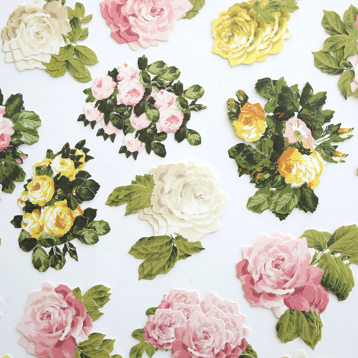 Rose Die Cut Embellishments feature assorted clusters of pink, white, and yellow roses with green leaves on a white background—ideal for card making or scrapbooking with beautiful rose-themed accents.