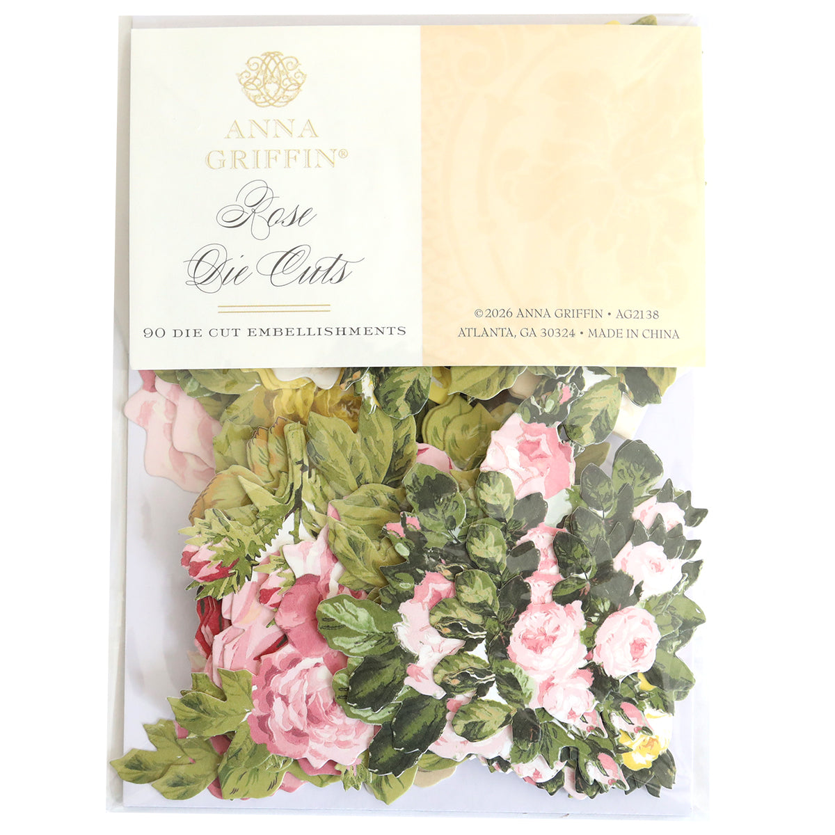 A package of Rose Die Cut Embellishments includes 90 floral pieces featuring pink and white roses with green leaves, ideal for card making or scrapbooking. The packaging displays product and brand information.