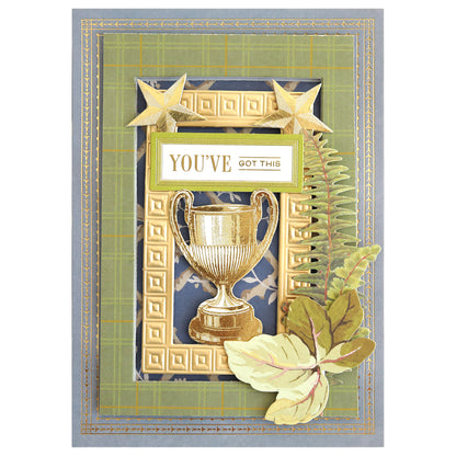 Introducing the Jack Double Sided Cardstock and Embellishments—a stunning greeting card design featuring a gold trophy, stars, fern leaves, and the uplifting text “YOU’VE GOT THIS” set against a vibrant green and plaid background with gold stitching and layered accents. Ideal for use as double sided cardstock or for enhancing your scrapbook pages with coordinating die cut embellishments.