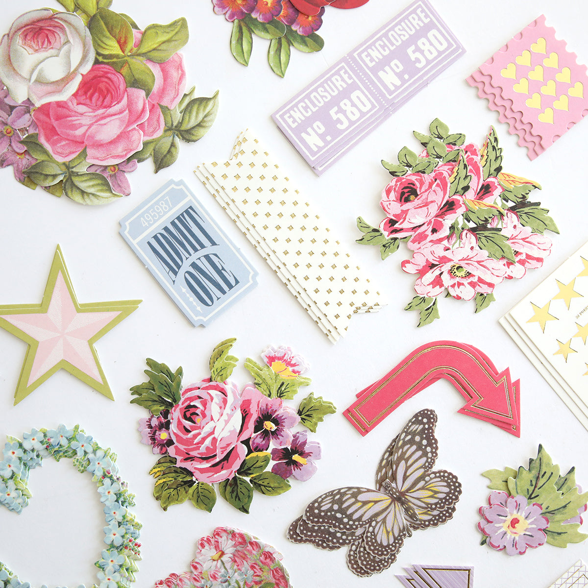 Charlie Die Cut Embellishments include decorative paper cutouts—flowers, tickets, stars, hearts, an arrow, a butterfly, and patterned shapes—ideal for crafts or scrapbooking and displayed on a white background.