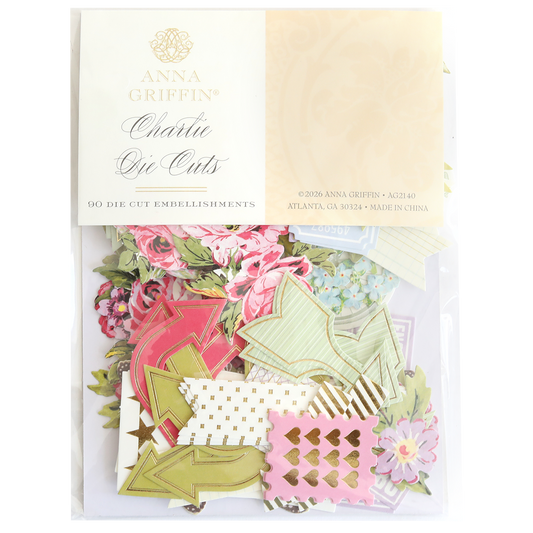 A package of Charlie Die Cut Embellishments contains assorted floral and patterned die cuts, including arrows and decorative shapes—ideal for craft supplies or scrapbook embellishments.